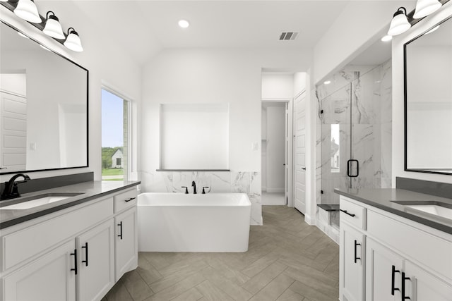 bathroom featuring separate shower and tub, vanity, and parquet flooring