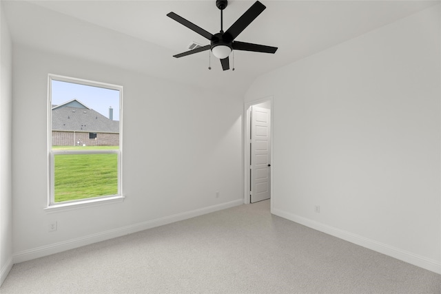 empty room featuring lofted ceiling, carpet flooring, and ceiling fan