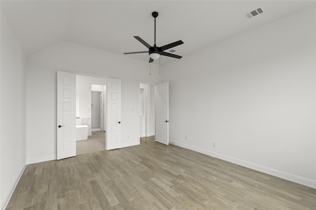 unfurnished bedroom featuring light hardwood / wood-style flooring, ceiling fan, and vaulted ceiling