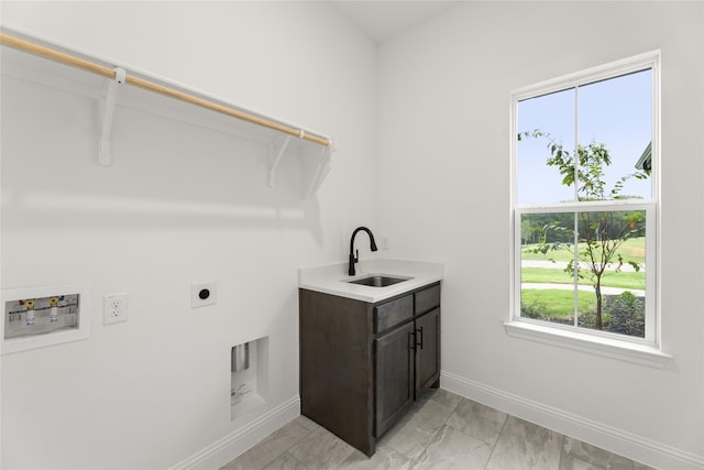 laundry room with sink, hookup for an electric dryer, and cabinets