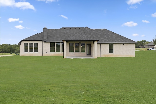 back of property featuring a patio and a yard