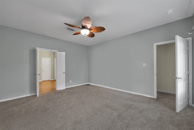 empty room with ceiling fan and light colored carpet