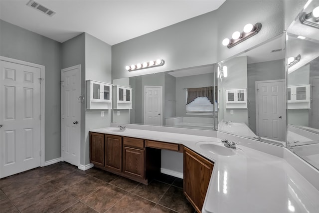 bathroom with tile patterned flooring and vanity