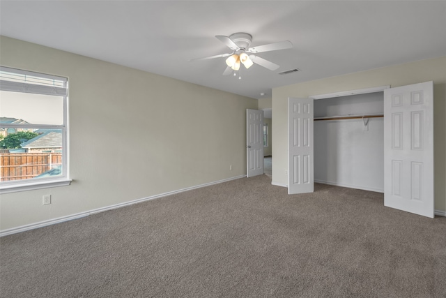 unfurnished bedroom with carpet, ceiling fan, and a closet