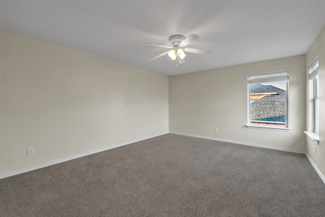 spare room featuring carpet and ceiling fan