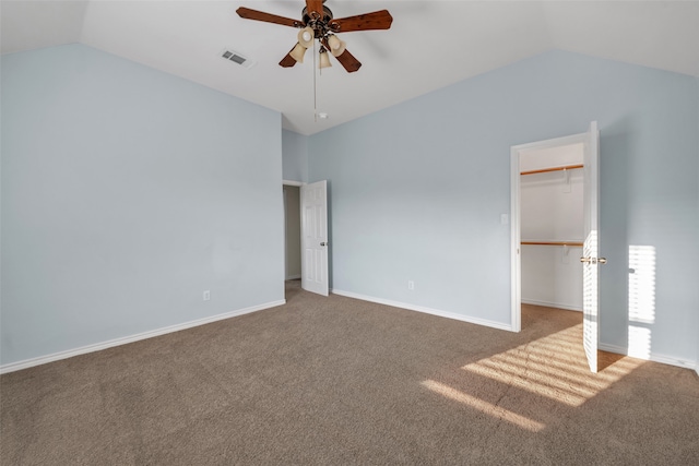 unfurnished bedroom featuring a spacious closet, ceiling fan, lofted ceiling, and a closet