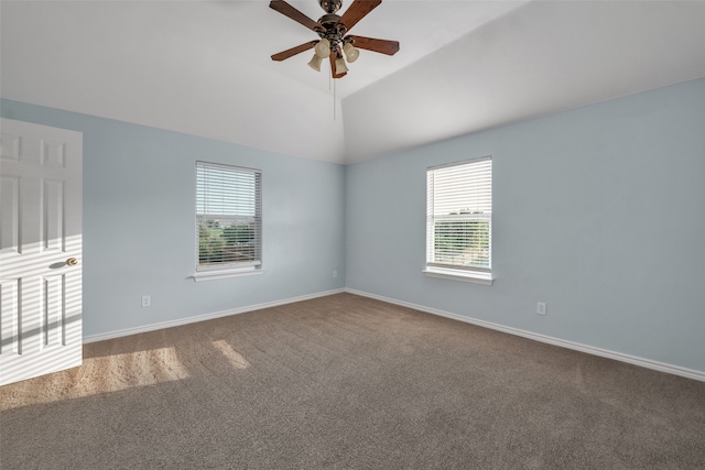 carpeted empty room with ceiling fan and vaulted ceiling