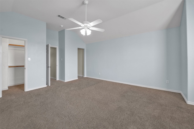 unfurnished bedroom featuring ceiling fan, a closet, carpet floors, and vaulted ceiling