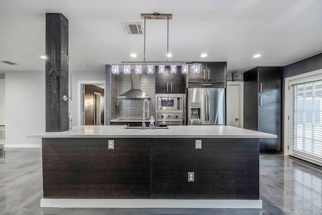 kitchen featuring sink, a center island with sink, concrete floors, and appliances with stainless steel finishes