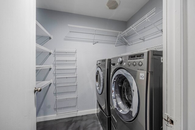 clothes washing area with separate washer and dryer