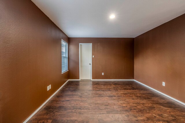 unfurnished room featuring dark hardwood / wood-style floors