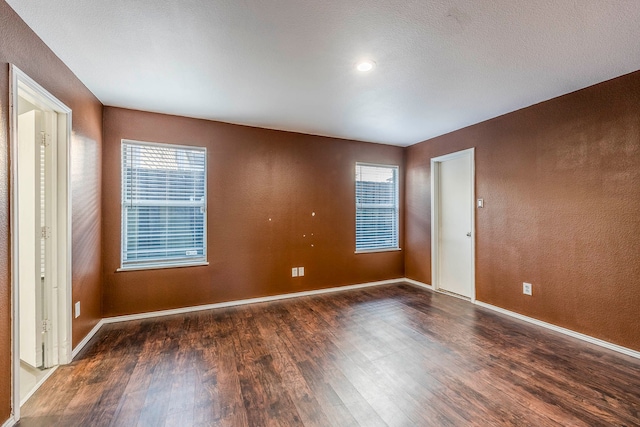 spare room with dark wood-type flooring