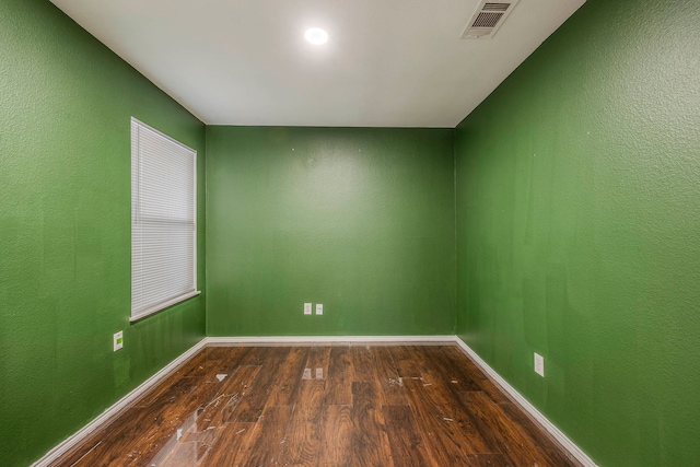 spare room with dark wood-type flooring