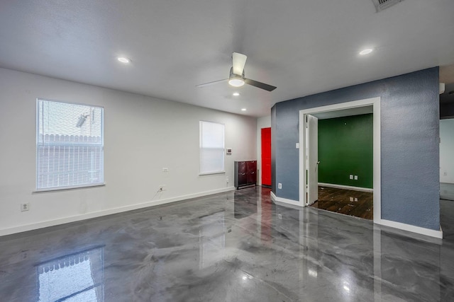 empty room featuring ceiling fan and plenty of natural light