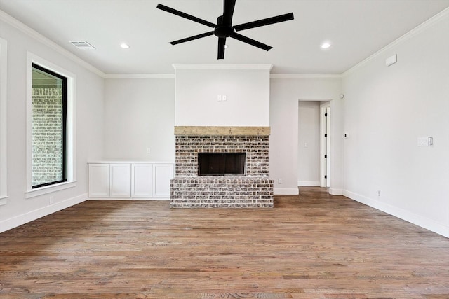 unfurnished living room with light hardwood / wood-style flooring, crown molding, a fireplace, and ceiling fan