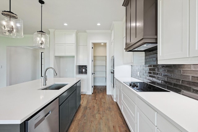 kitchen with pendant lighting, sink, stainless steel appliances, custom range hood, and white cabinets