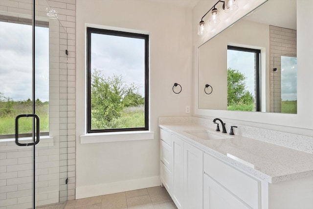 bathroom featuring tile patterned flooring, vanity, and a shower with shower door