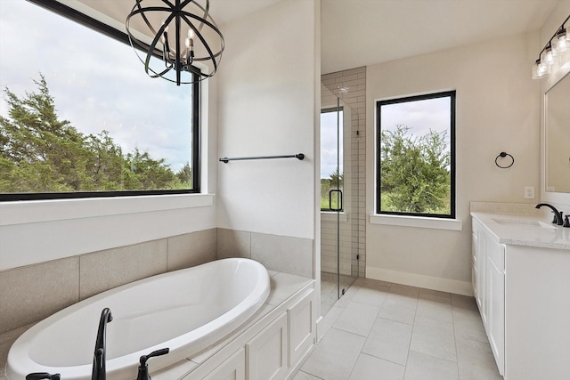 bathroom with vanity, shower with separate bathtub, a wealth of natural light, and tile patterned floors