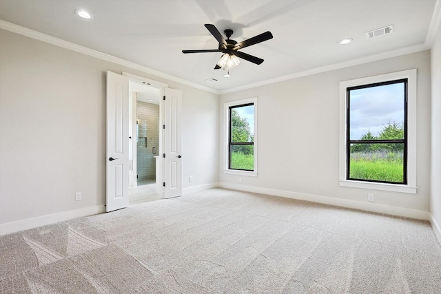 carpeted spare room with crown molding and ceiling fan