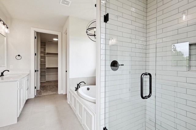 bathroom featuring vanity, independent shower and bath, and tile patterned flooring