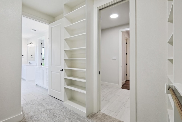 hall featuring light tile patterned floors