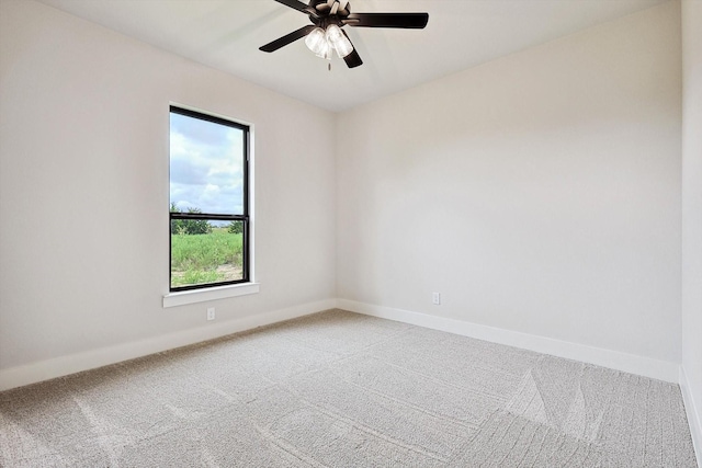 empty room featuring plenty of natural light, carpet flooring, and ceiling fan