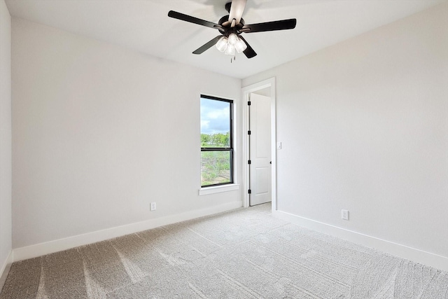 empty room with light colored carpet and ceiling fan