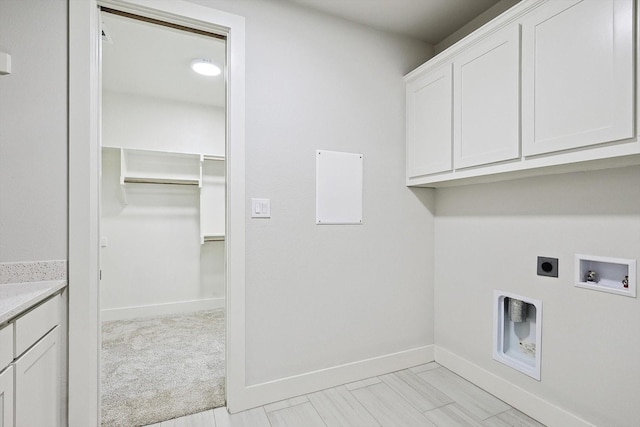 clothes washing area with cabinets, washer hookup, light carpet, and electric dryer hookup