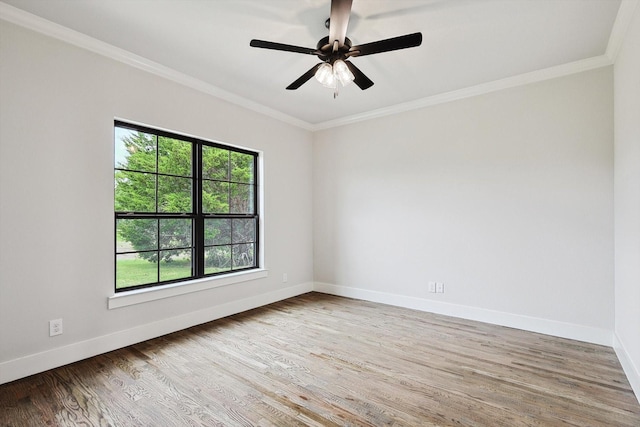 unfurnished room featuring ornamental molding, plenty of natural light, wood-type flooring, and ceiling fan