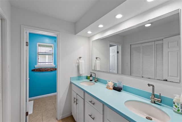 bathroom with dual sinks, oversized vanity, and tile floors