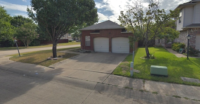 view of front of home with a front yard and a garage