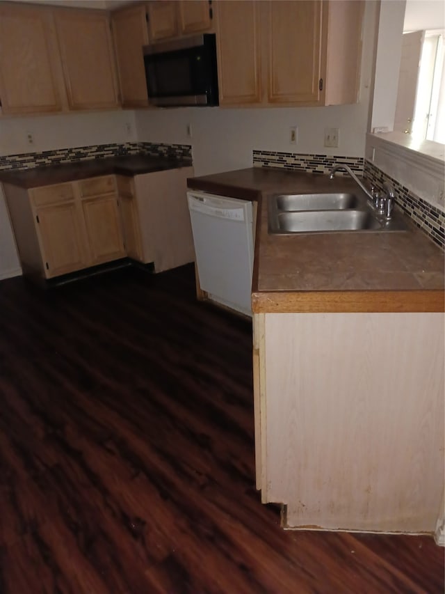 kitchen featuring light brown cabinetry, sink, white dishwasher, and dark wood-type flooring