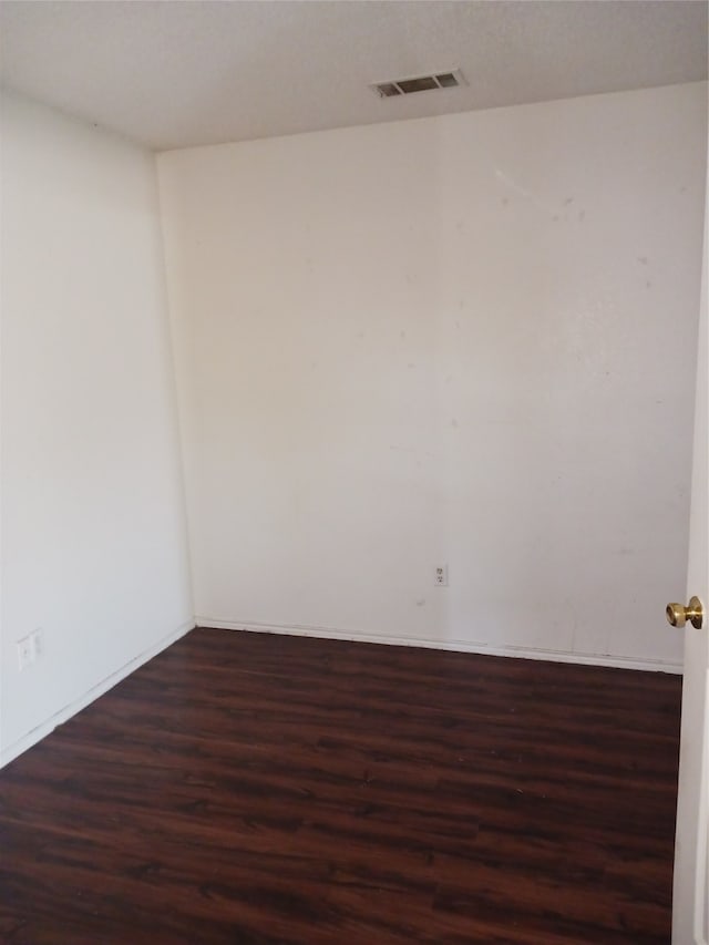 empty room with dark wood-type flooring