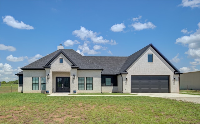 view of front of home with a front lawn and a garage