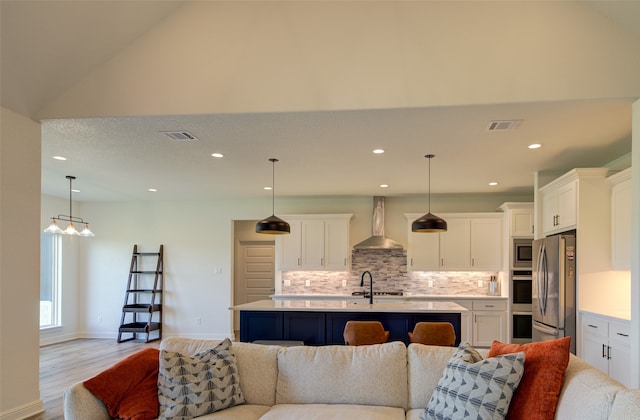 living room featuring light hardwood / wood-style flooring and lofted ceiling