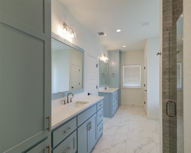 bathroom with tile flooring, double sink vanity, and an enclosed shower