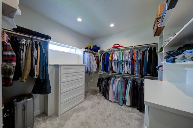 walk in closet featuring light carpet and radiator