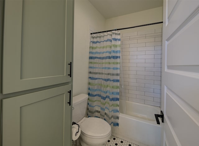 bathroom with tile flooring, shower / tub combo, and toilet