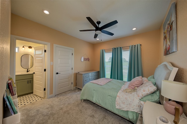 carpeted bedroom featuring ensuite bathroom and ceiling fan