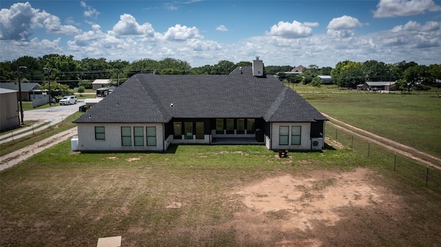 back of house featuring a lawn