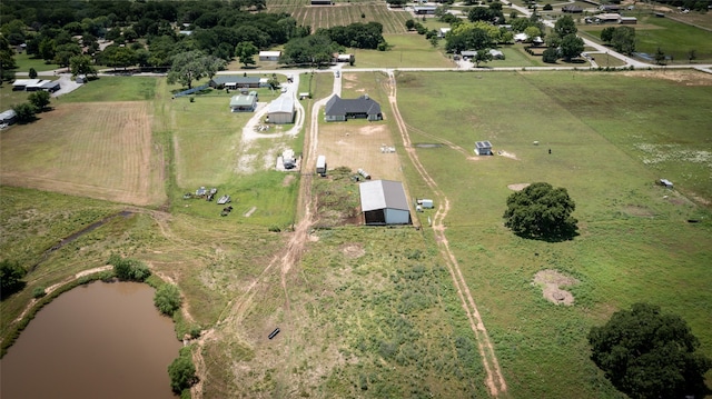 birds eye view of property featuring a rural view and a water view