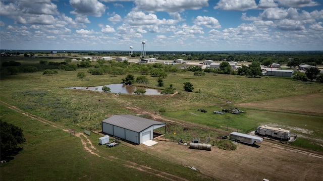 birds eye view of property featuring a water view and a rural view