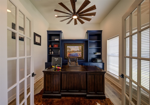 home office featuring dark wood-type flooring and french doors