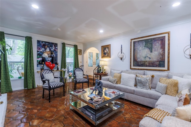 living room featuring ornamental molding and dark tile patterned flooring