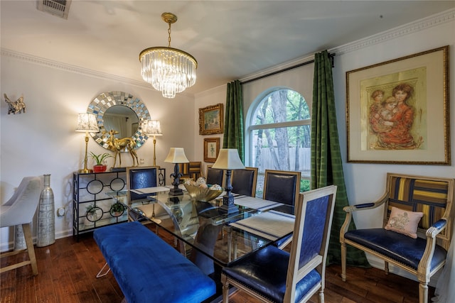 dining space featuring an inviting chandelier, crown molding, and dark wood-type flooring