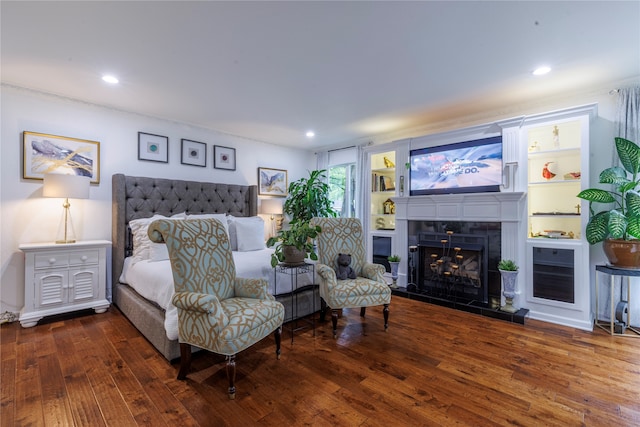 bedroom featuring dark wood-type flooring and a fireplace