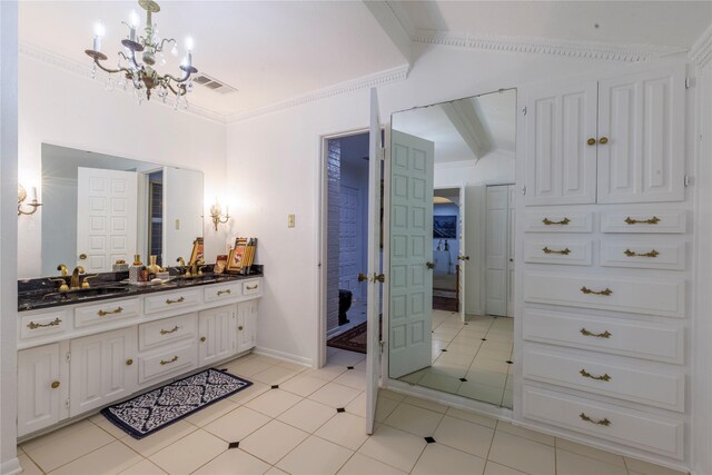 bathroom with vanity, ornamental molding, lofted ceiling, and tile patterned flooring