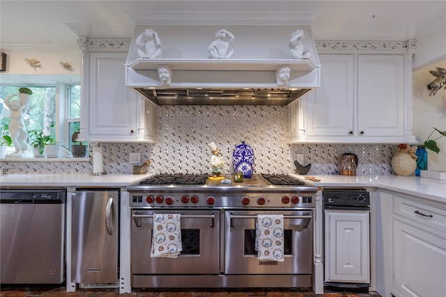 kitchen with decorative backsplash, stainless steel appliances, white cabinets, custom range hood, and ornamental molding