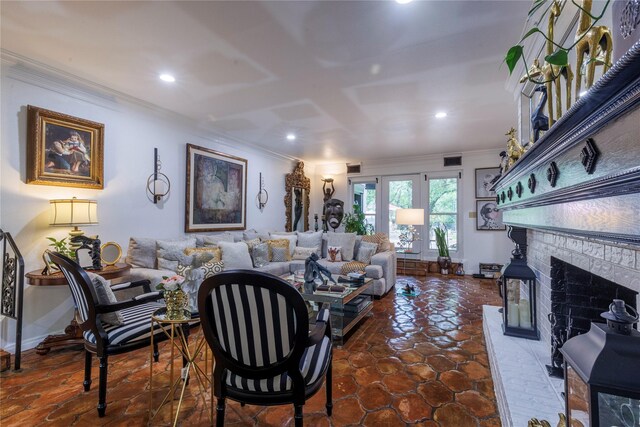 living room featuring crown molding, a fireplace, and tile patterned flooring