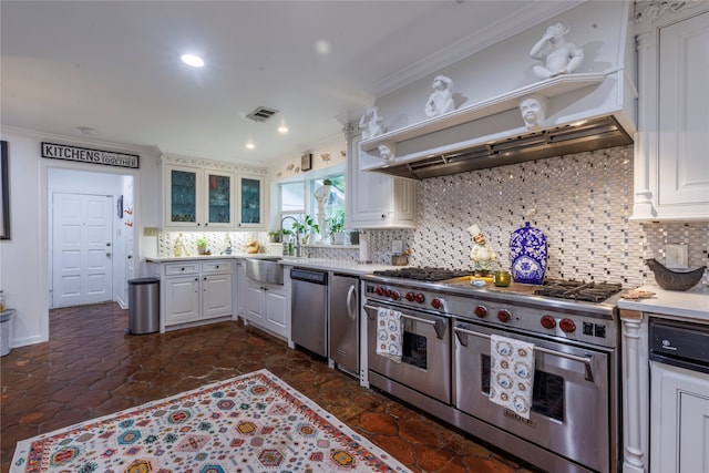 kitchen featuring white cabinets, tasteful backsplash, appliances with stainless steel finishes, premium range hood, and crown molding